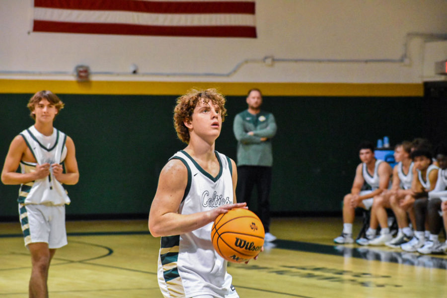 Senior Eric Morgan throws a free throw at the pre-season game. Photo taken by Giana DiPietro
