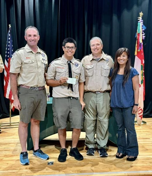 Elarde standing next to his parents and leader at the Fall Court. 
Boy Scout Troop 226 Facebook page