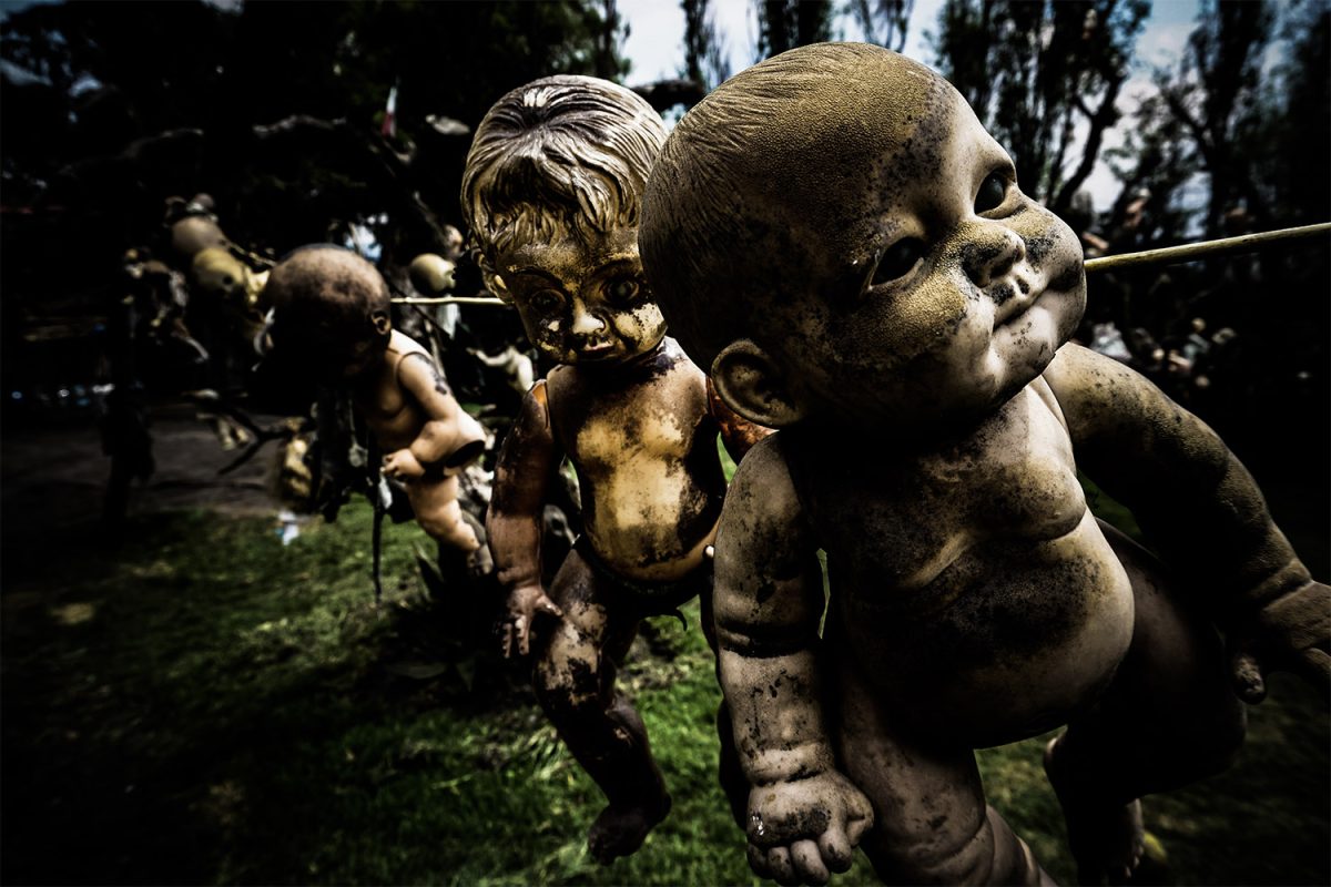 A set of the island’s mutilated dolls are strung along a wire.